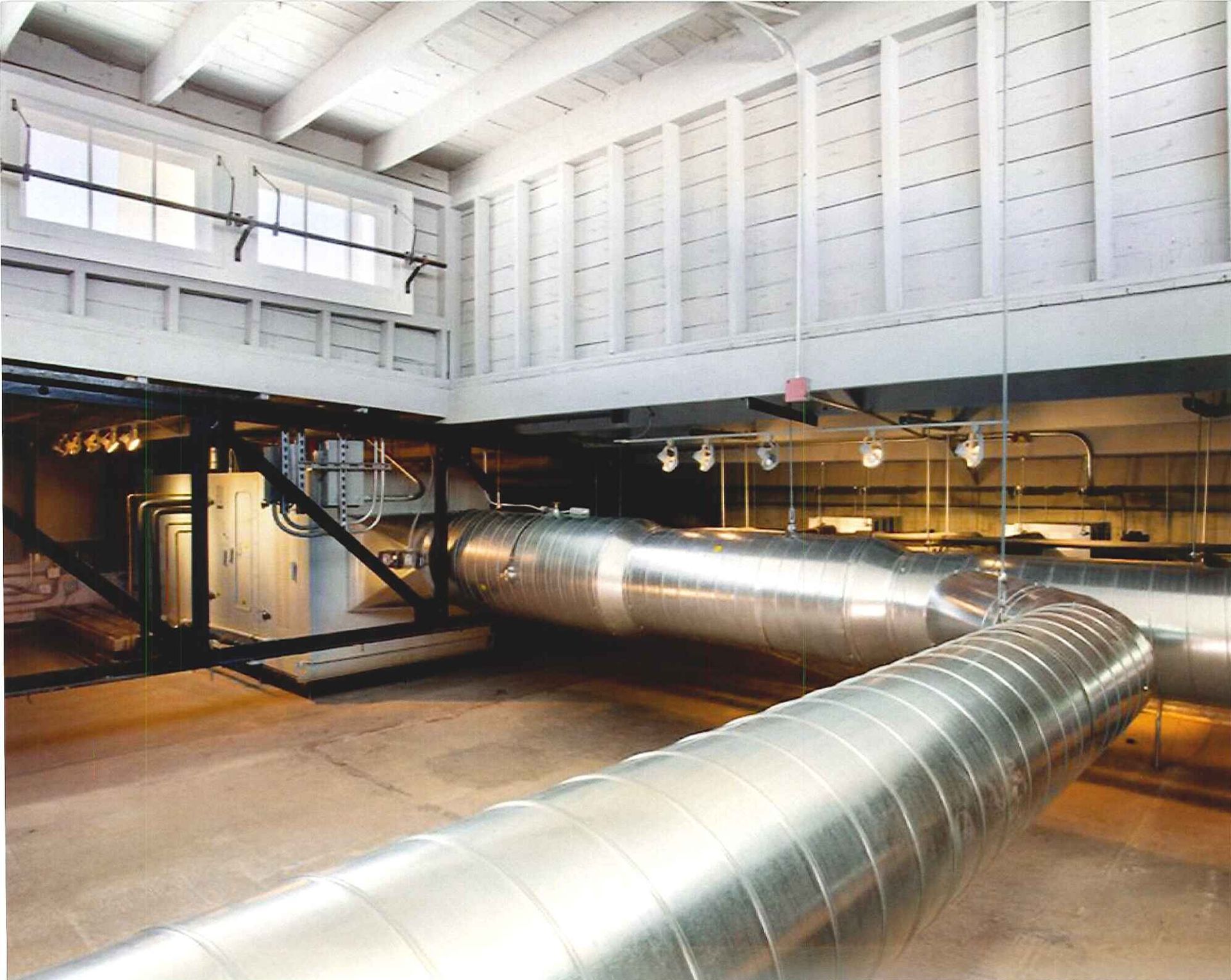 A large room with a lot of pipes going through it