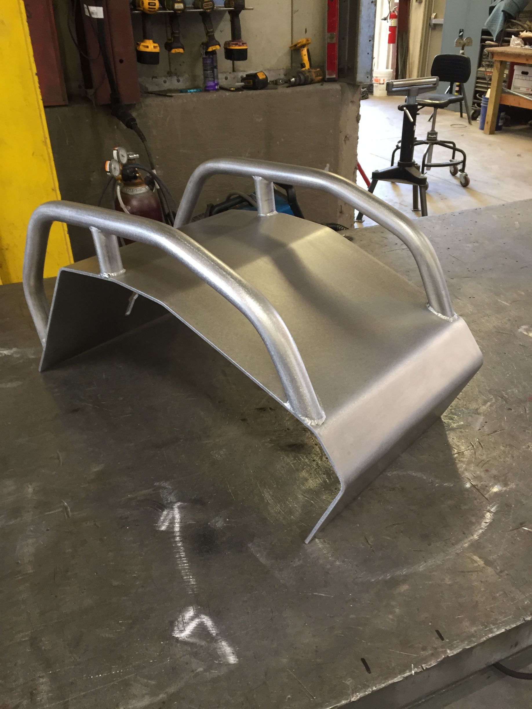 A piece of metal is sitting on a table in a workshop.