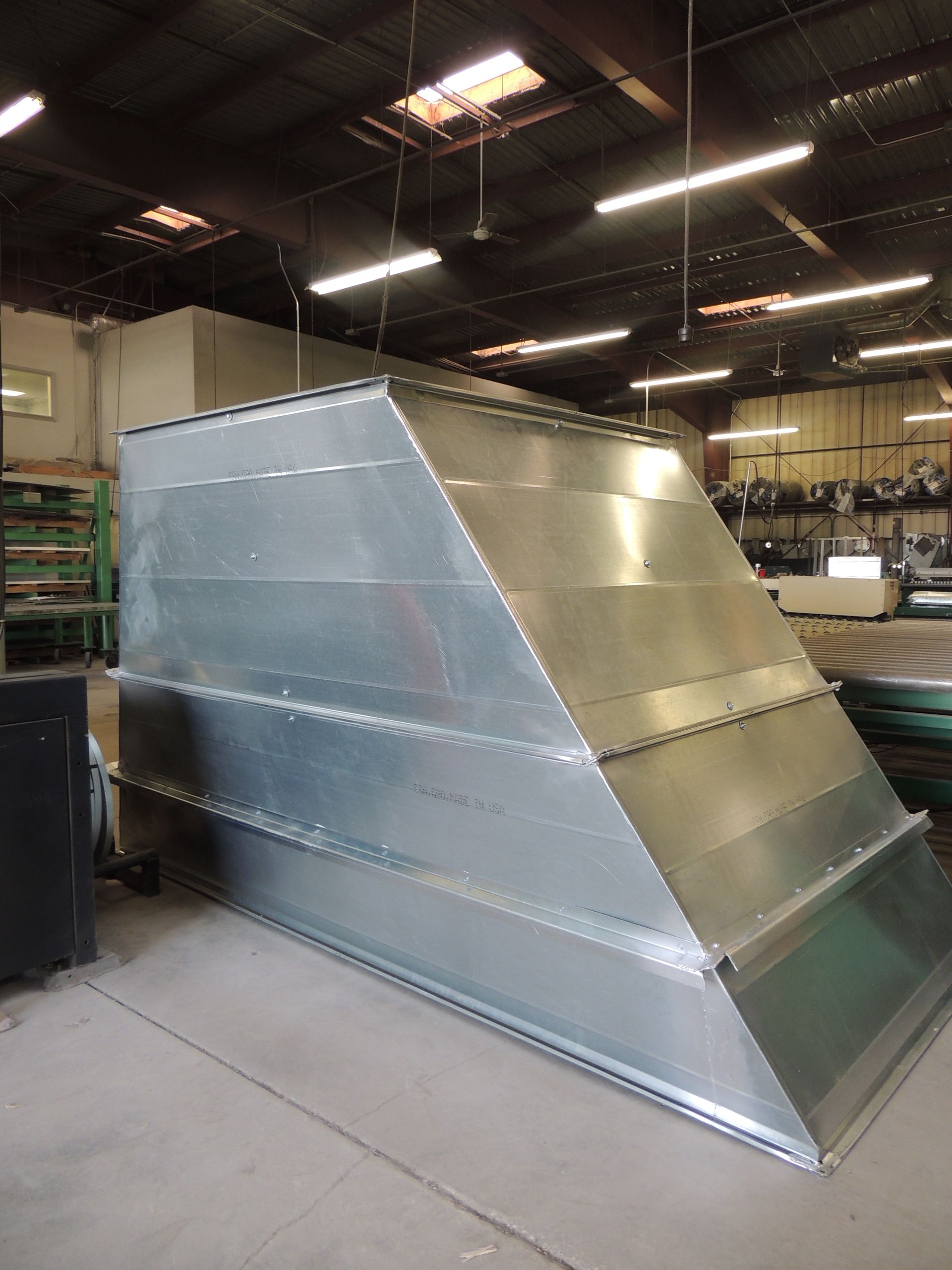 A large metal pipe is sitting in a warehouse.