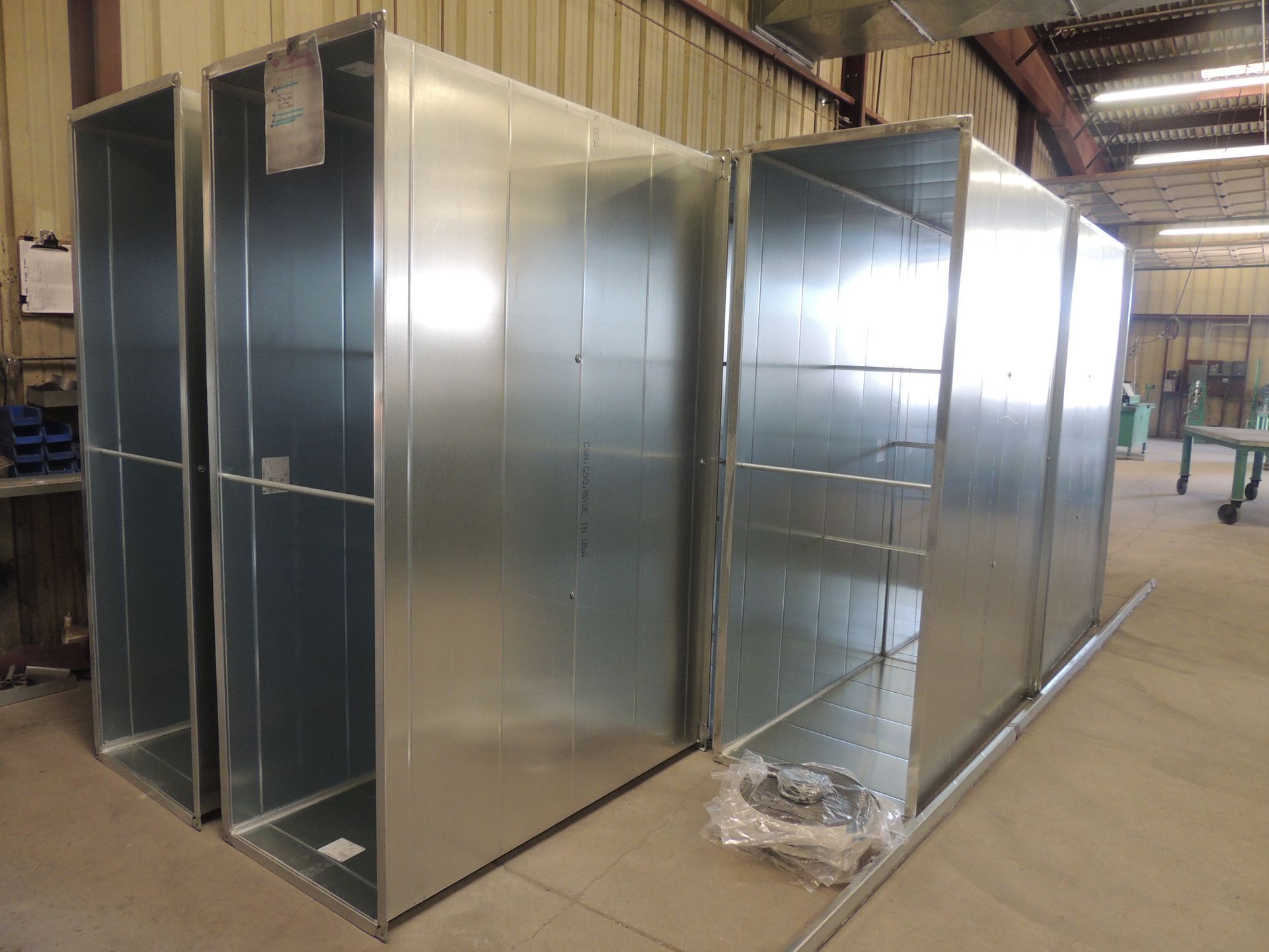 A row of metal ducts sitting next to each other in a building.