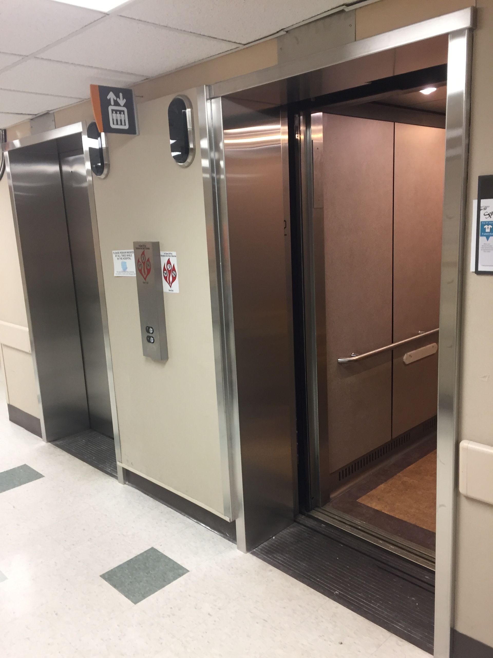 A row of elevators with the number 12 on the wall