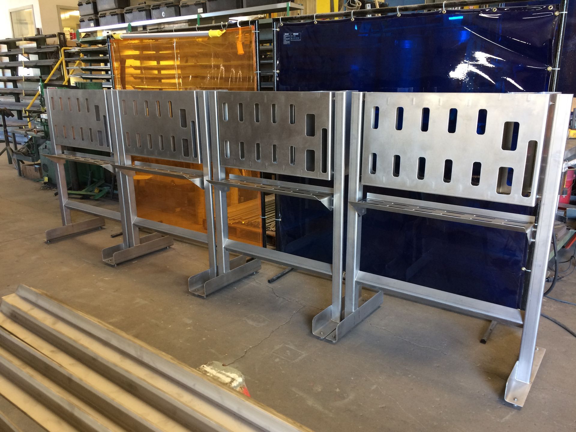 A row of metal fences are sitting in a warehouse.