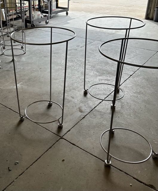 Two metal tables with wheels are sitting on a tiled floor.