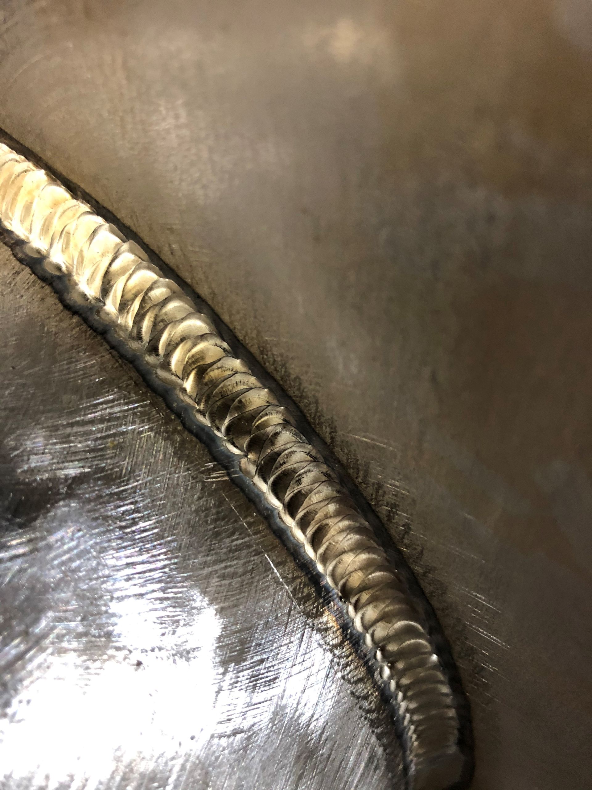 A close up of a welding joint on a metal surface.
