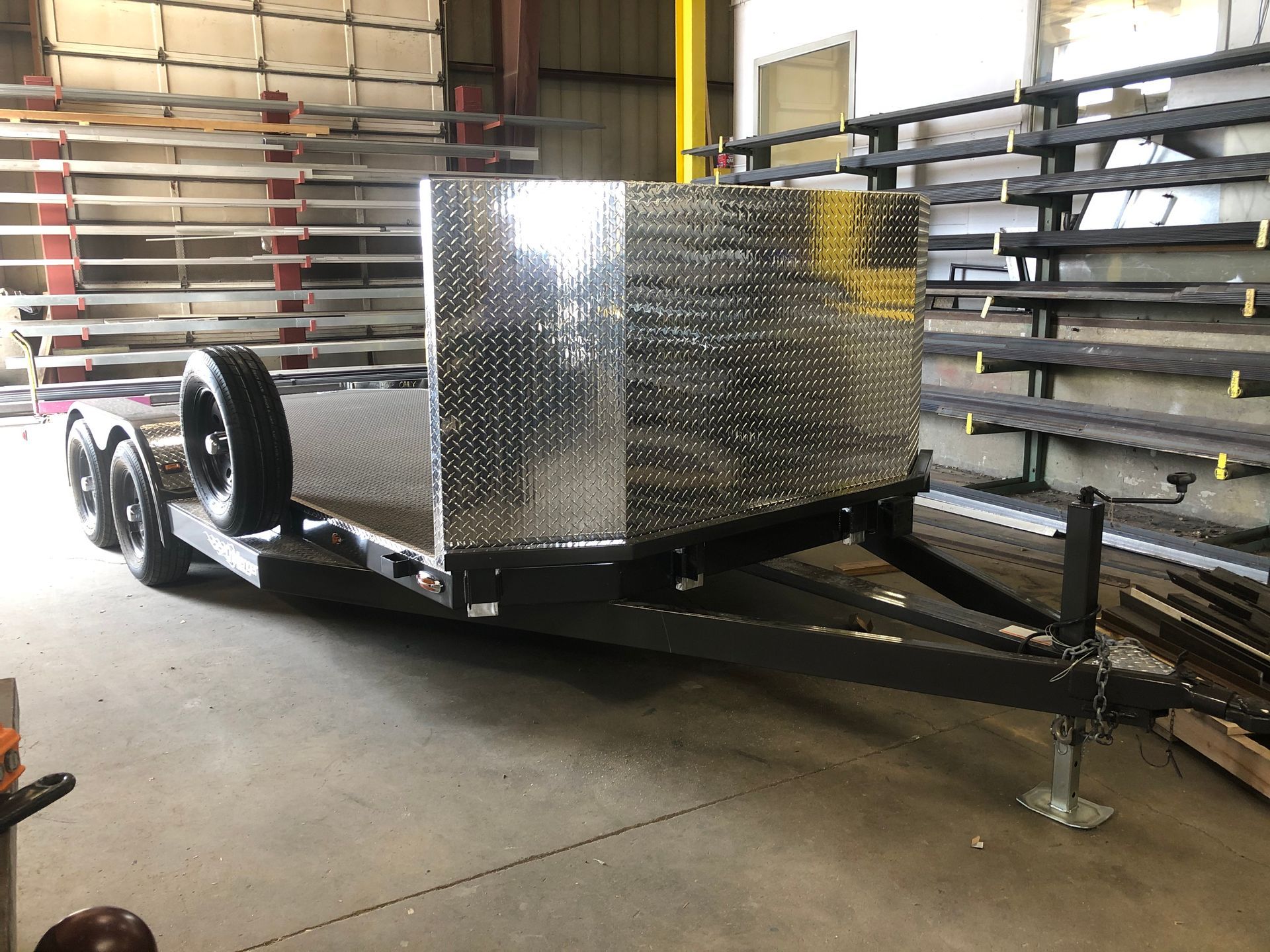 A trailer is sitting in a warehouse next to a wall.