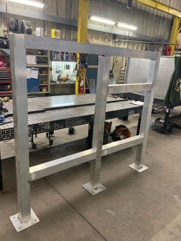 A stainless steel railing is being built in a factory.