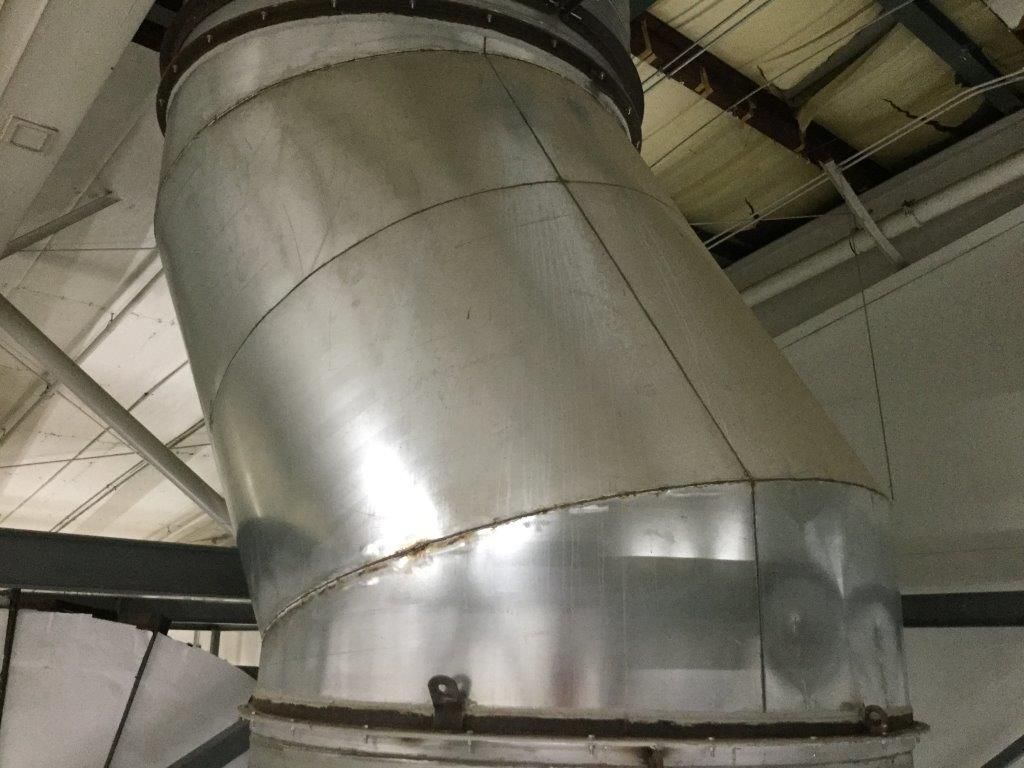 A large metal pipe is hanging from the ceiling of a building.