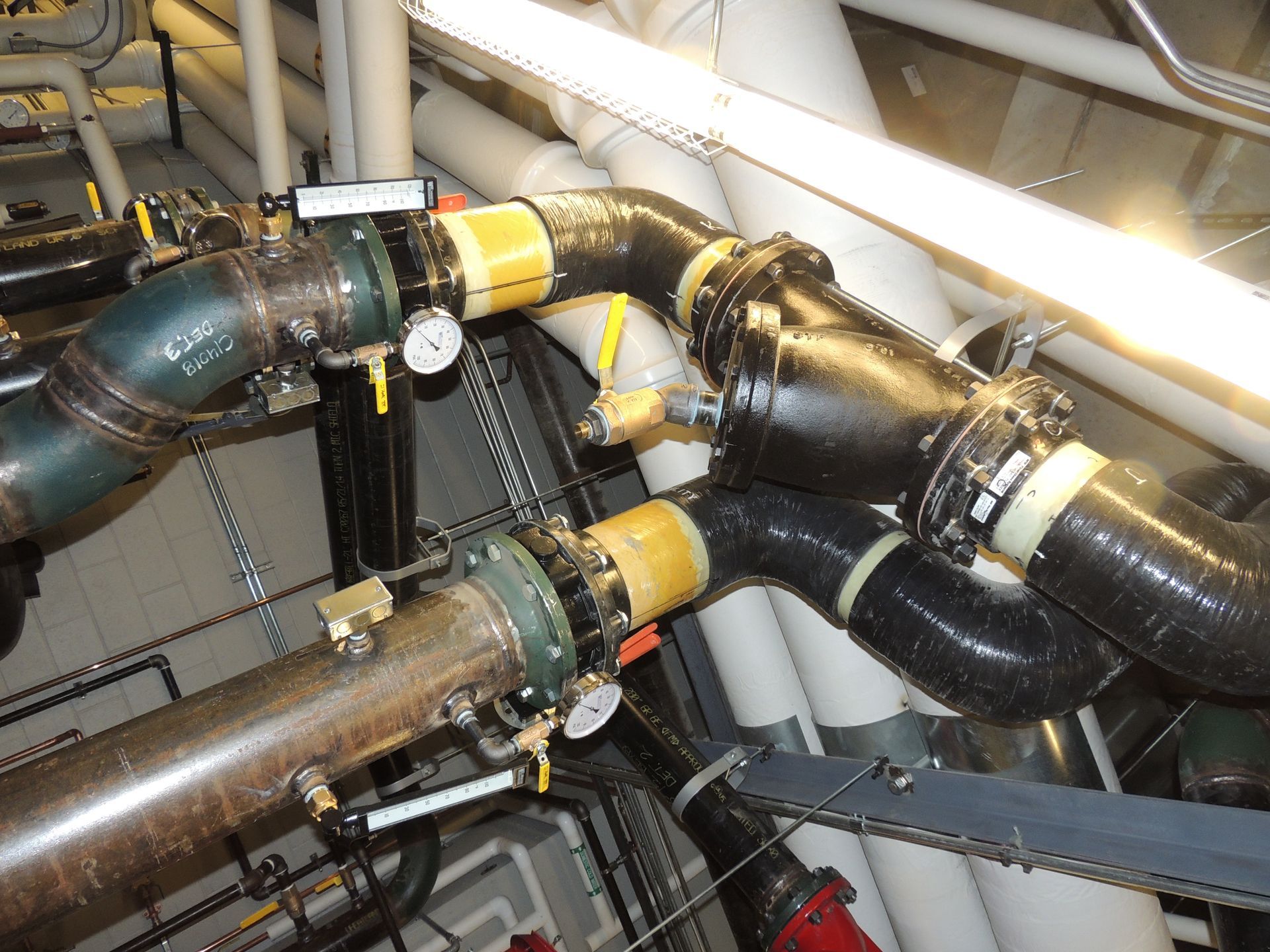 A bunch of pipes are connected to each other in a room