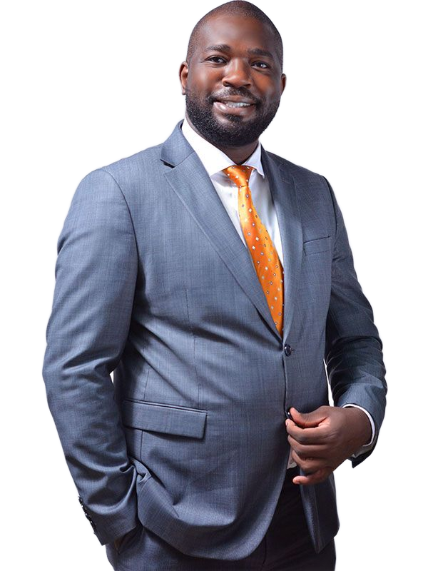 A Black man in a gray suit and orange tie smiles, posed against a white background.