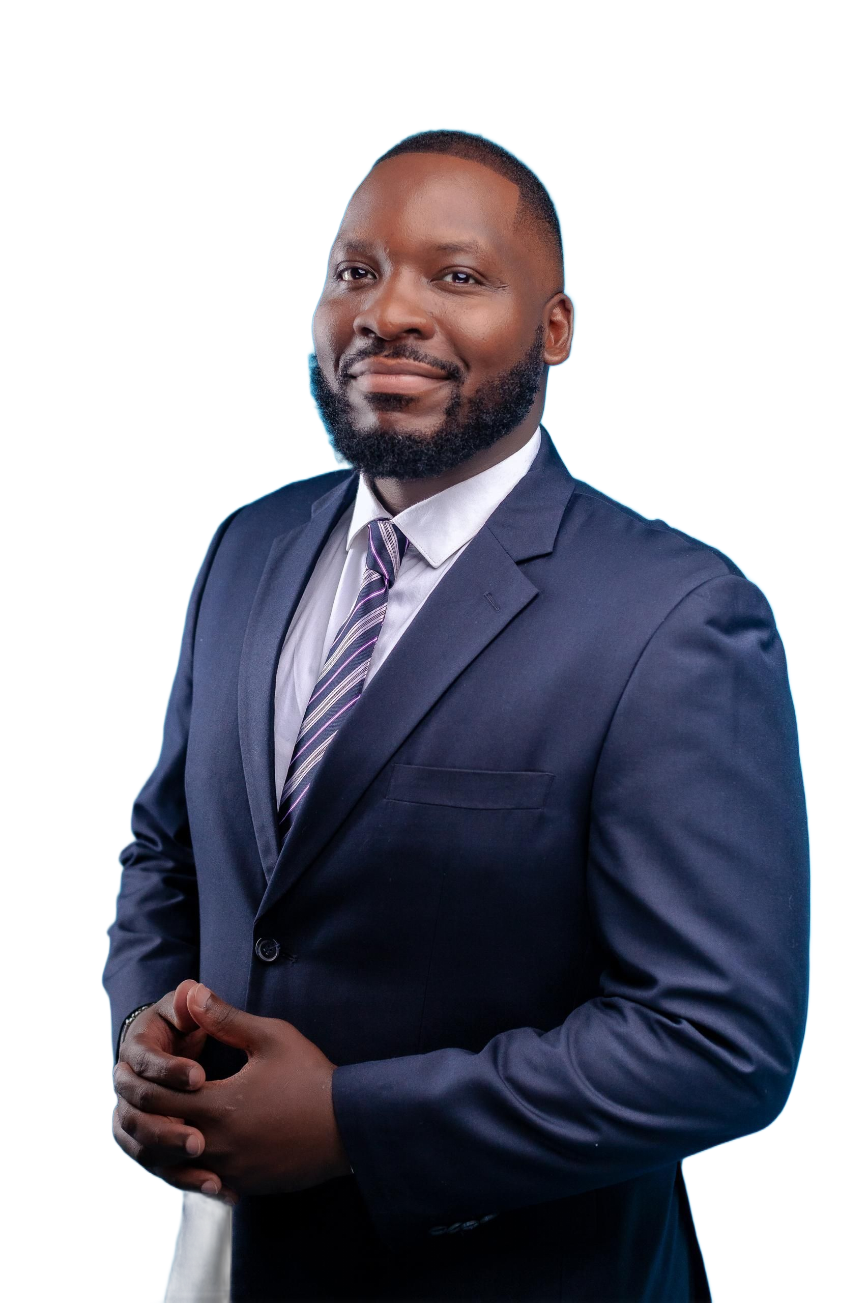 Man in a dark blue suit and tie smiles, hands clasped, against a white background.