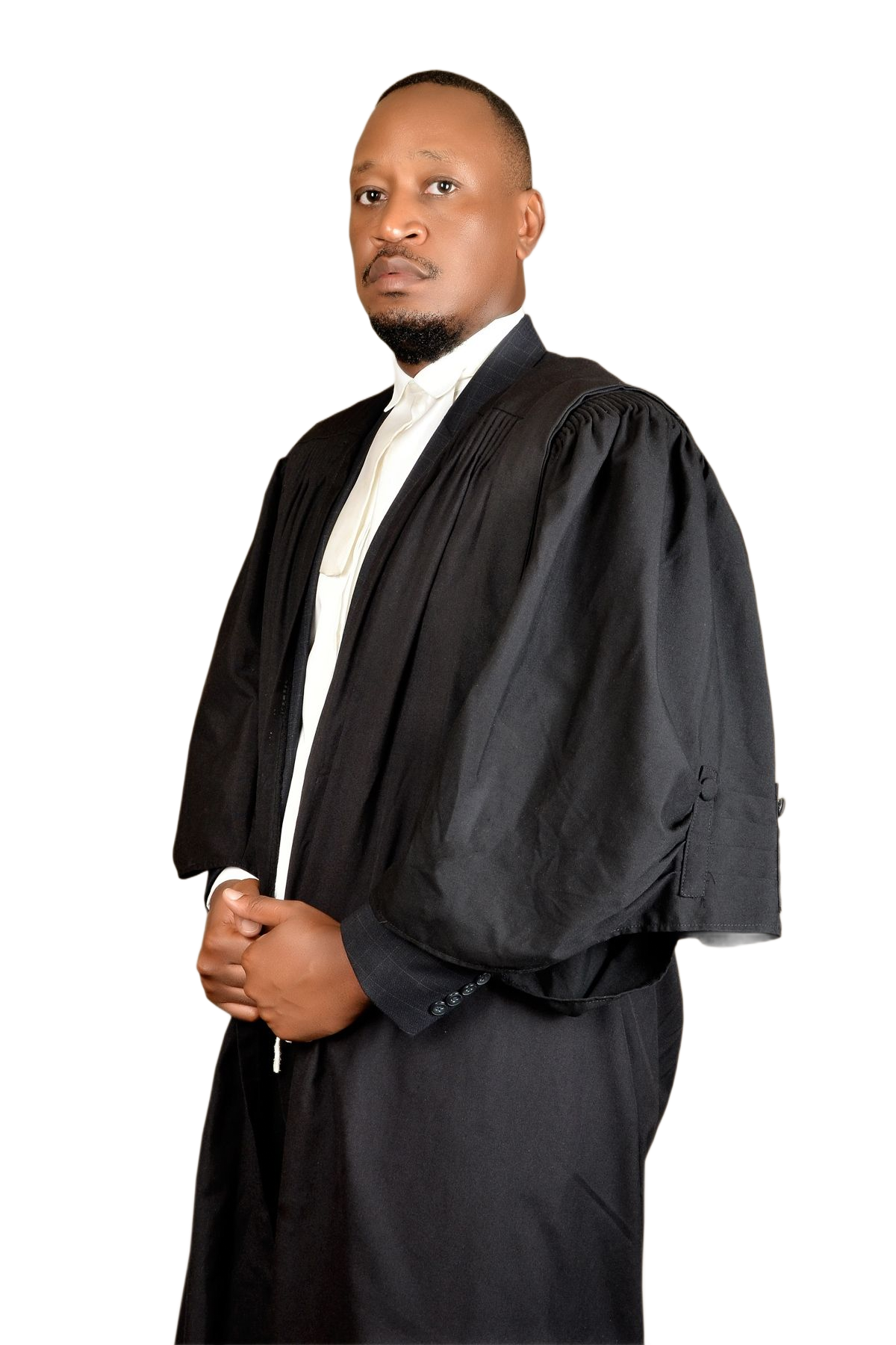 Man in black legal robes, arms crossed, standing against a white background.