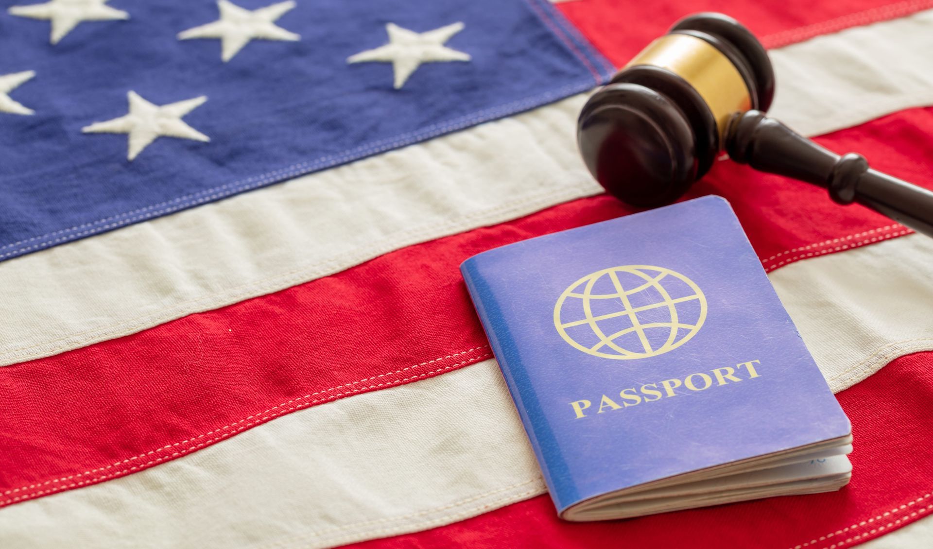 U.S. flag with passport and gavel, symbolizing travel or immigration law