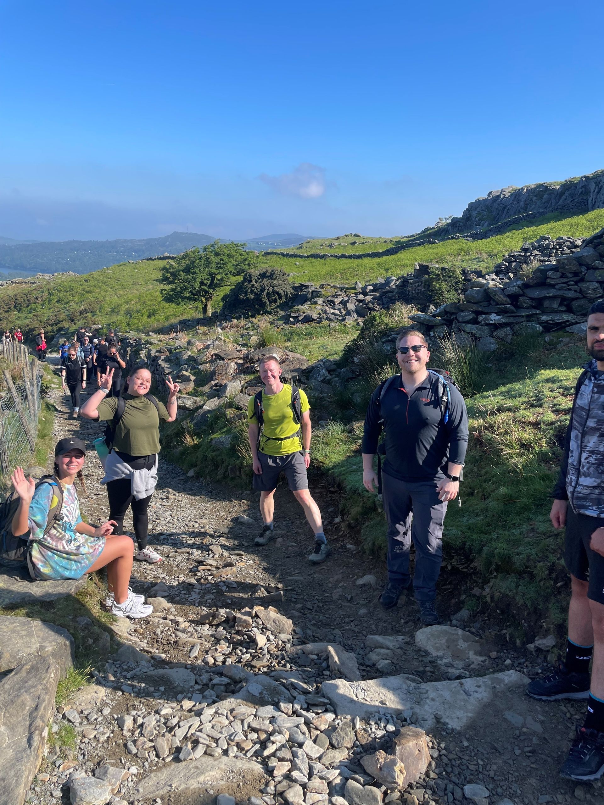 A group of people are standing on top of Snowdon.