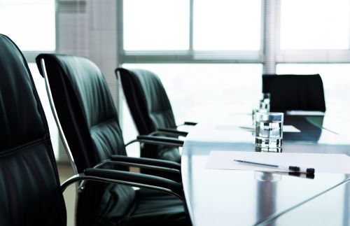 A conference room with a long table and chairs