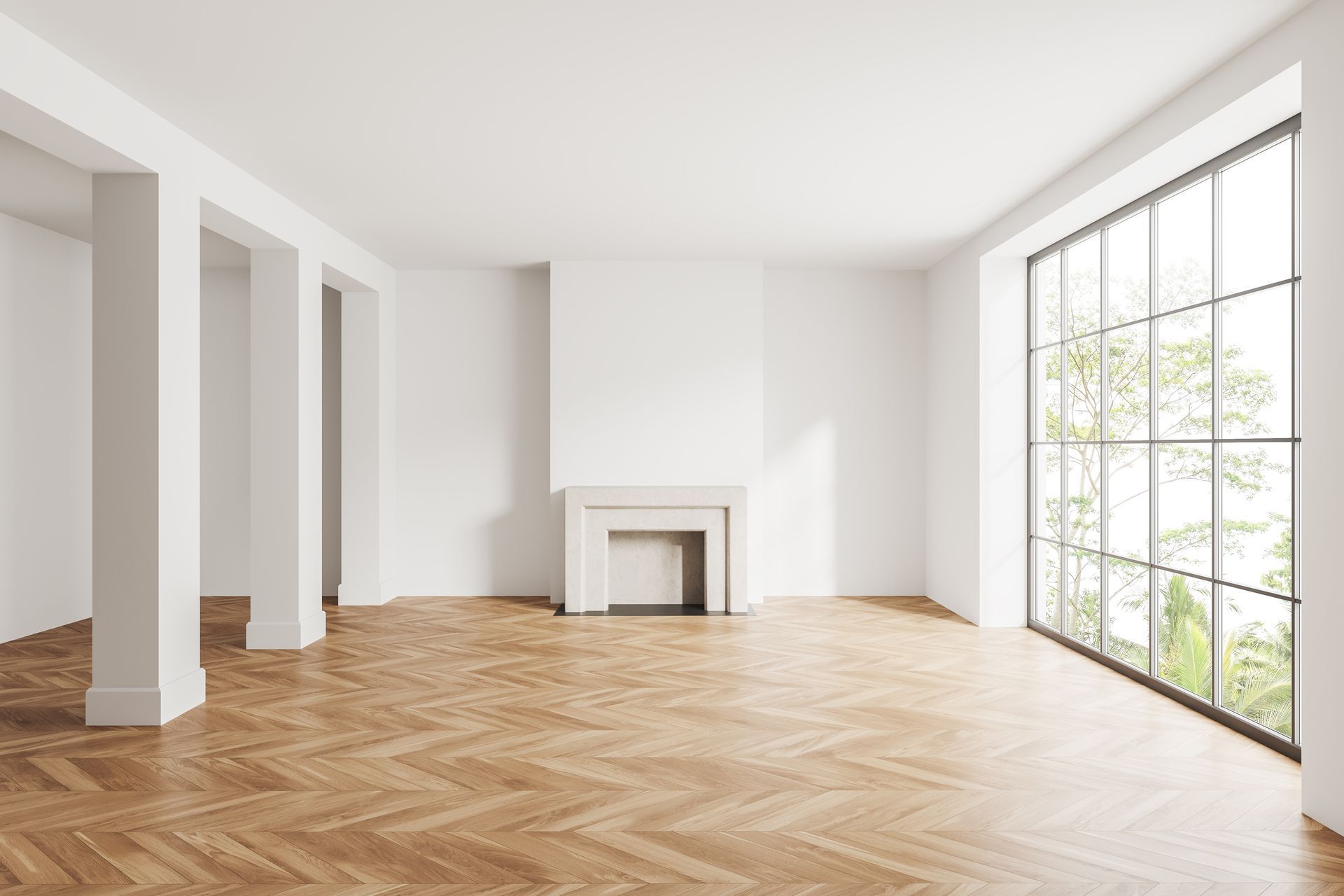 An empty living room with a fireplace and large windows.