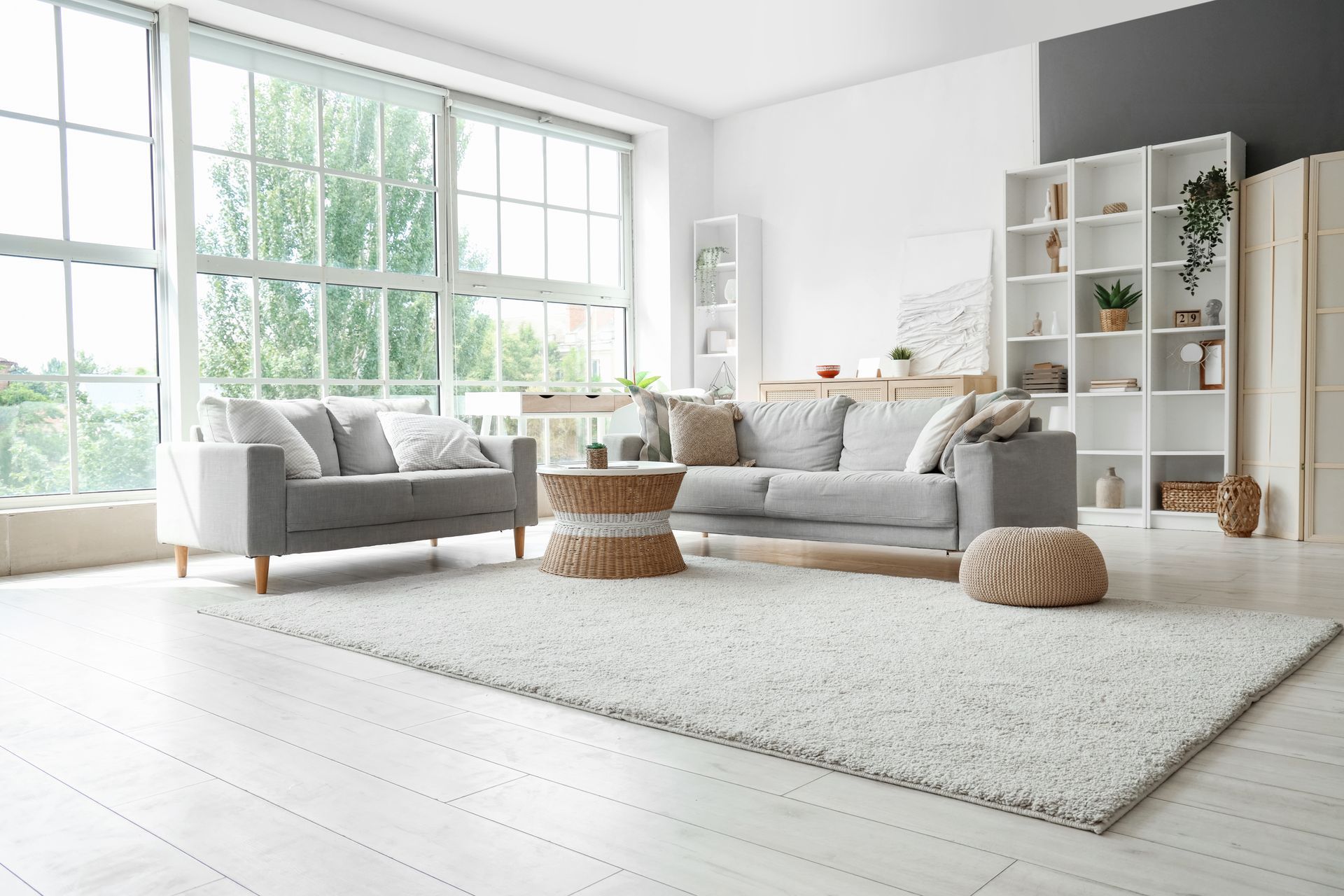A living room with two couches , a coffee table , and a rug.