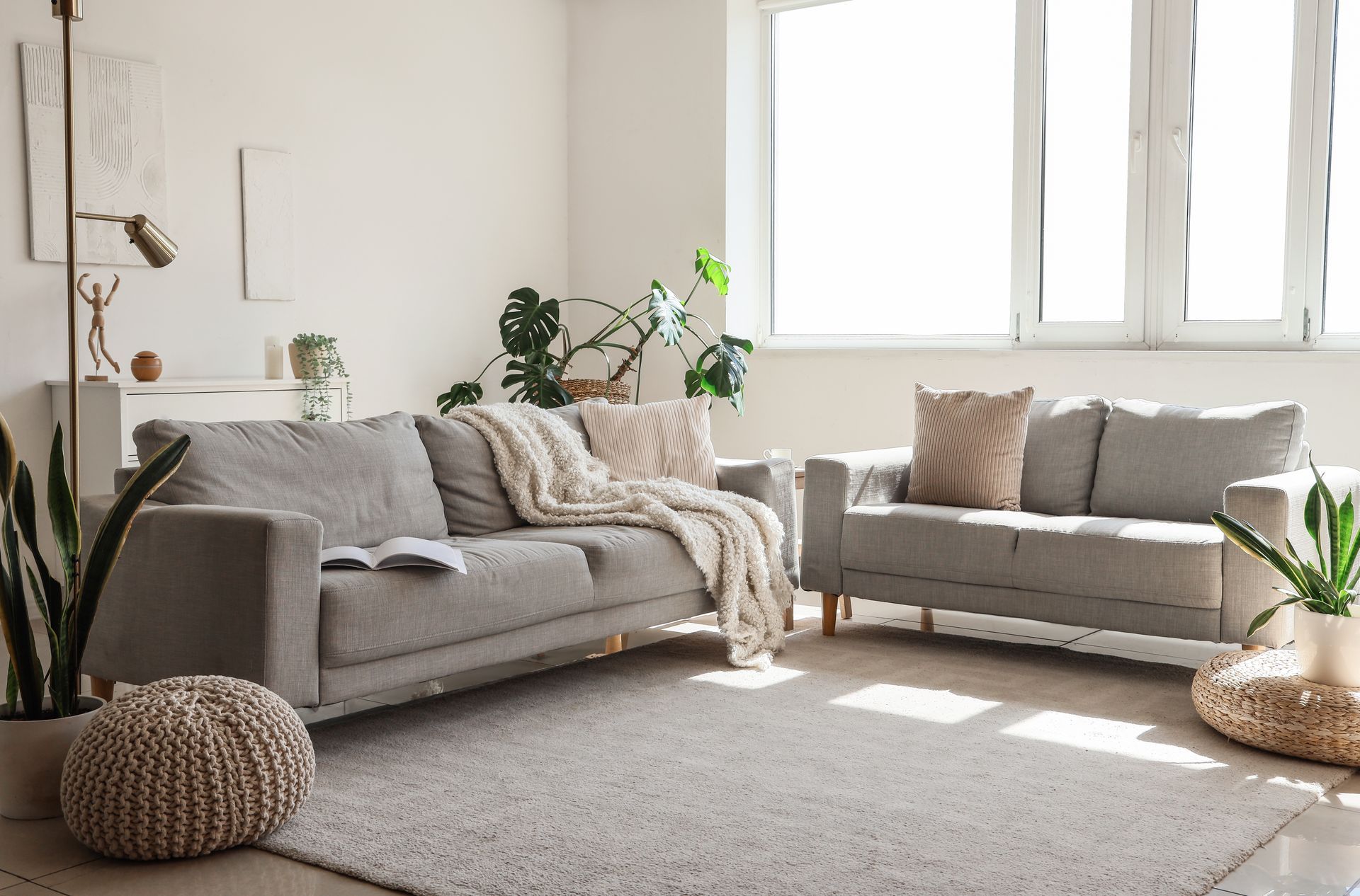 A living room with two couches and a rug.