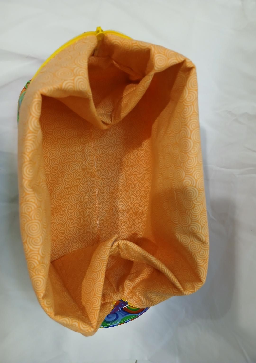 Orange reusable tote bag shown open, with gathered fabric edges on a white background