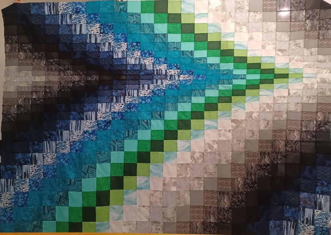 Abstract mosaic with blue, green, and beige diagonal patterns converging to the center