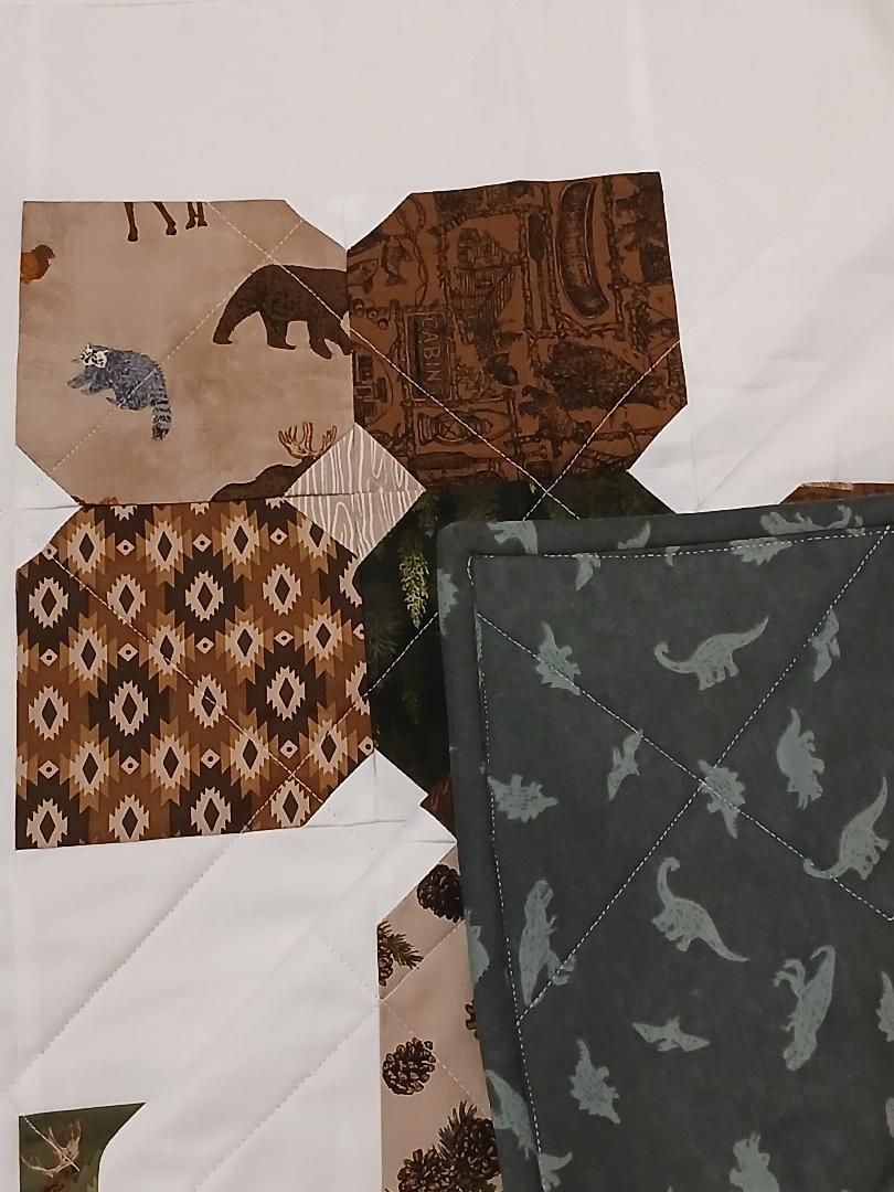 Assorted fabric swatches with animal and geometric patterns in brown, green, and beige on a white background