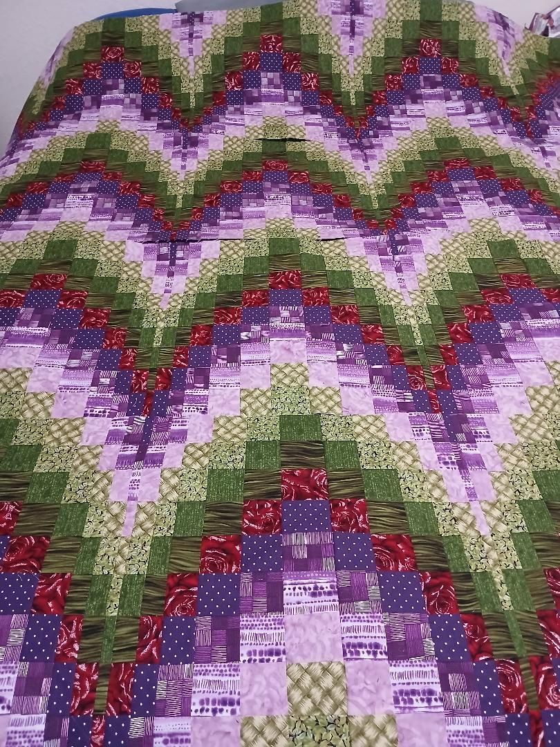 Colorful abstract zigzag pattern in purple, green, red, and white