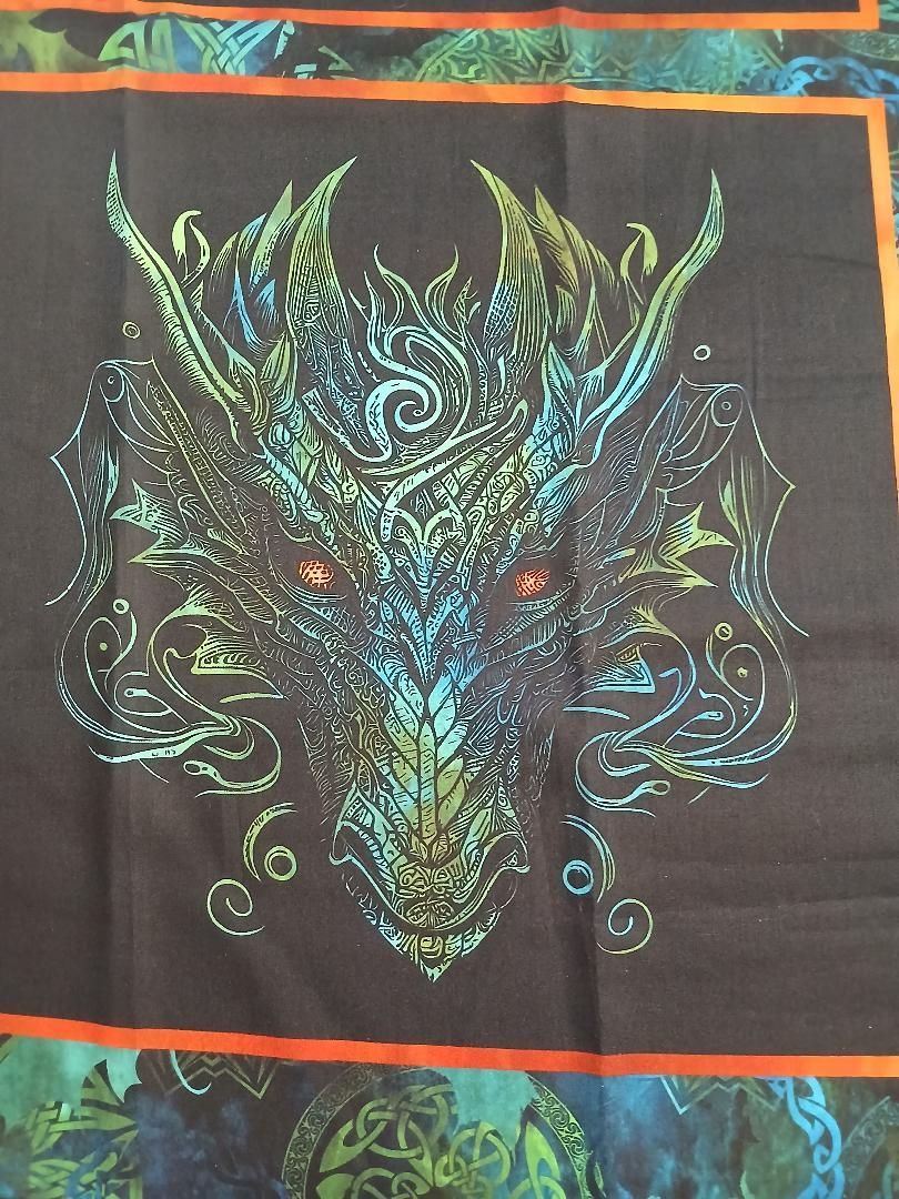 Colorful tribal wolf design with swirling blue, green, and teal patterns on a dark background.