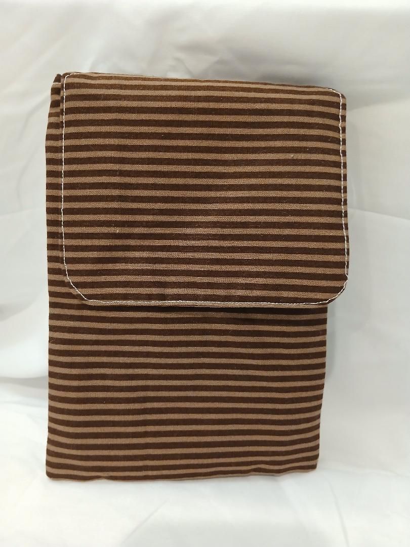 Brown striped folded fabric on a white background