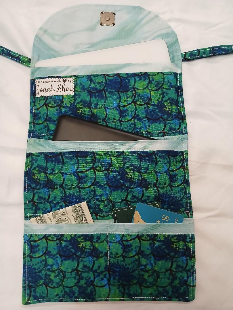 Blue-green patterned hanging organizer with three pockets and small labels