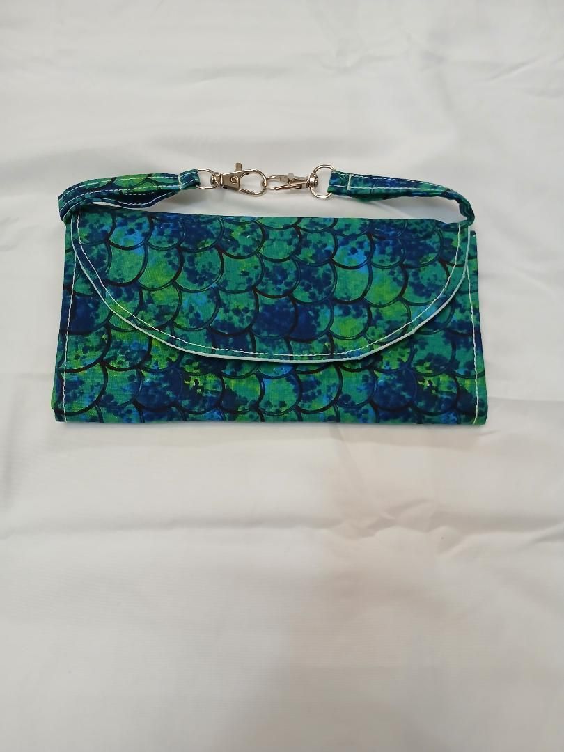 Blue-green patterned clutch purse on a light background