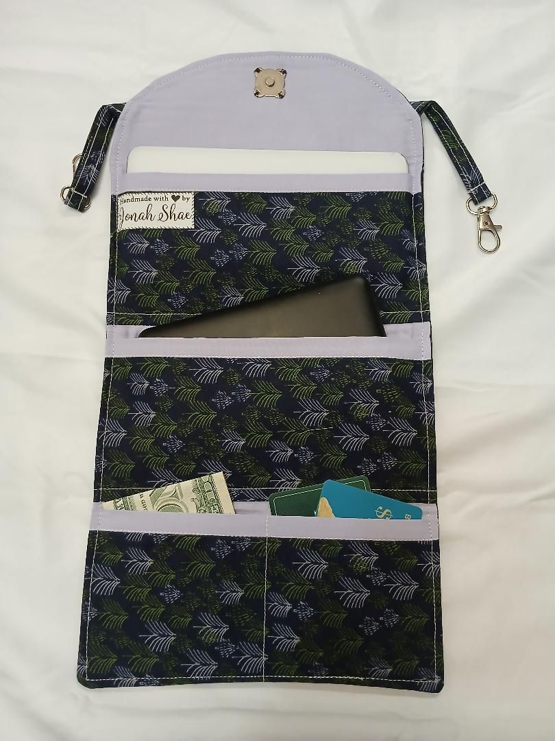 Floral fabric hanging organizer with three pockets and a lavender top and straps