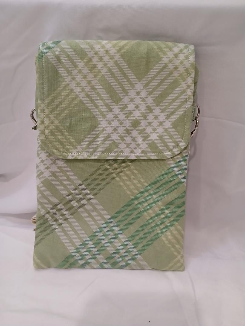 Green plaid fabric pouch with a flap, shown against a white background