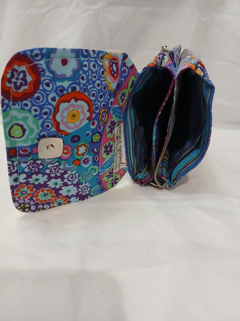 Colorful floral zippered pouch and matching open wallet on white background