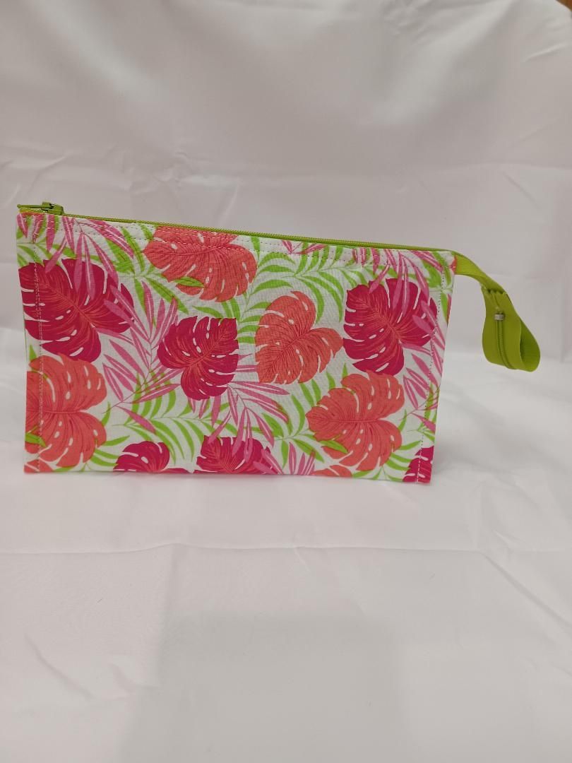 Colorful floral fabric pouch with a green tassel on a white background