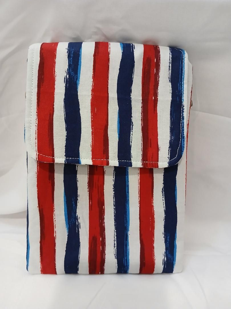 Small folded pouch with vertical red, white, and blue stripes on a light background