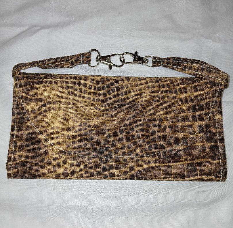 Brown leopard-print handbag with a strap and silver clasp on a white background