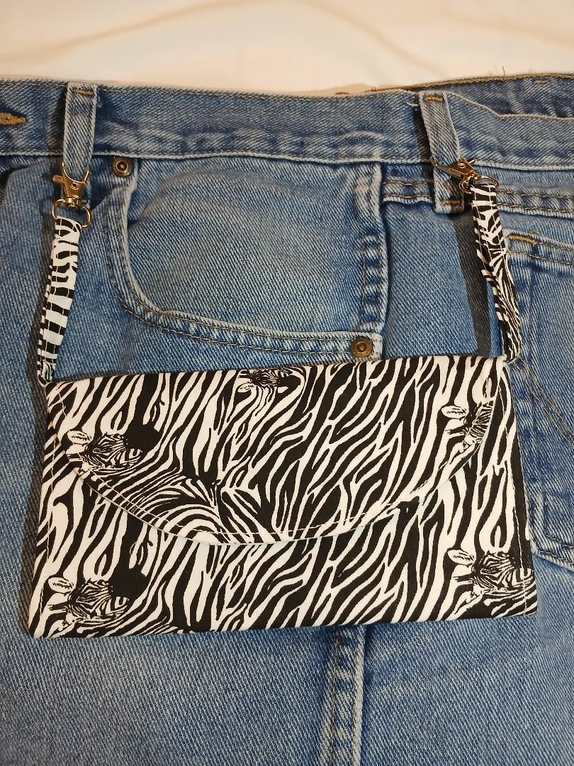 Denim jeans with a small zebra-print pocket and silver stud details