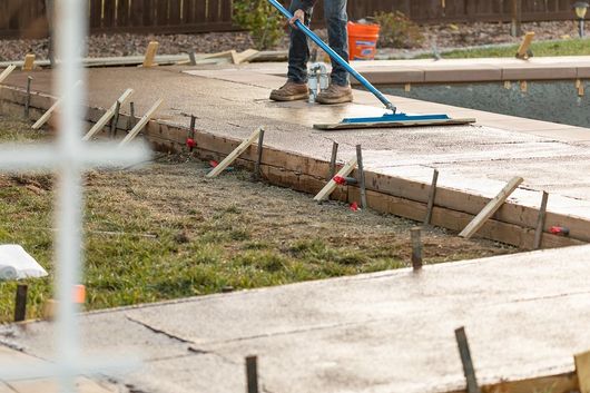worker in boots standing in the concrete slab