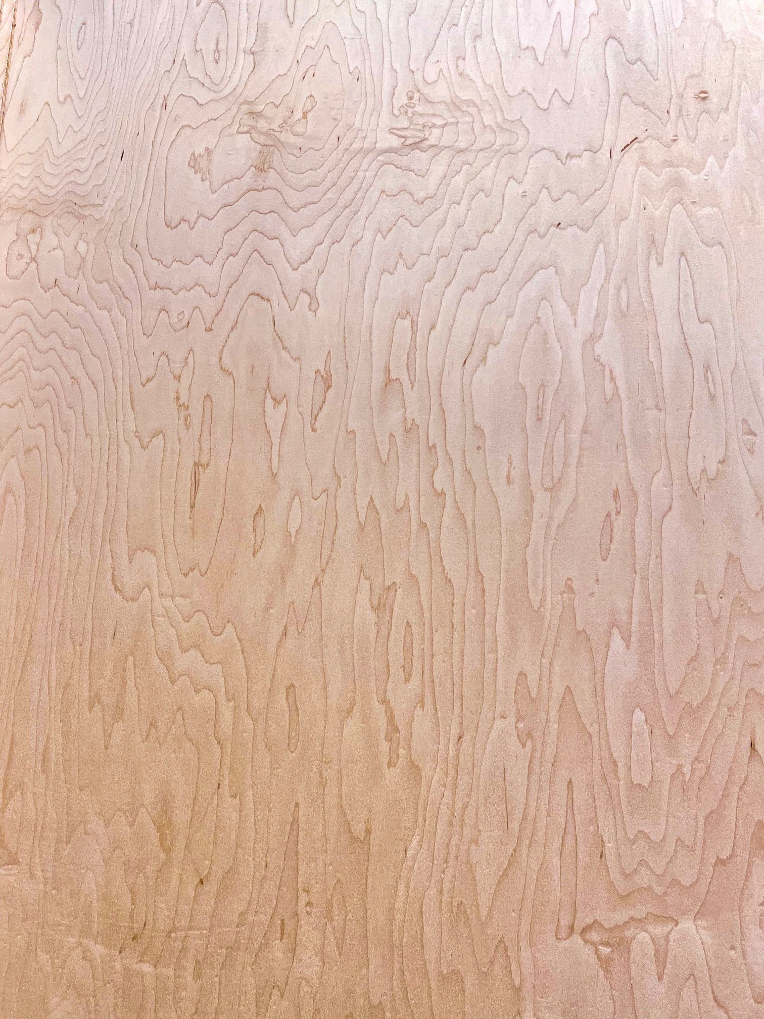A close up of a piece of wood with a grain pattern.