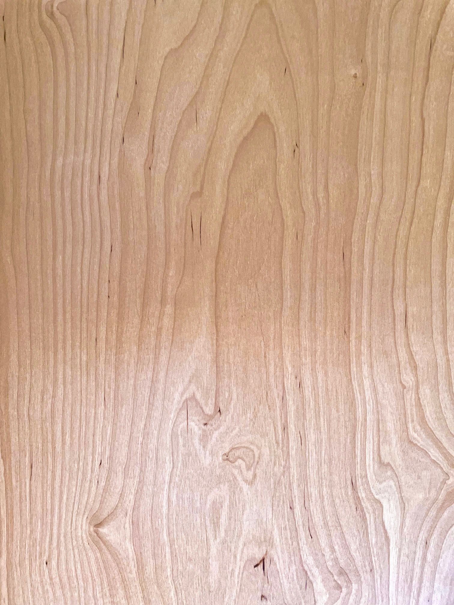 A close up of a piece of wood with a grain pattern.