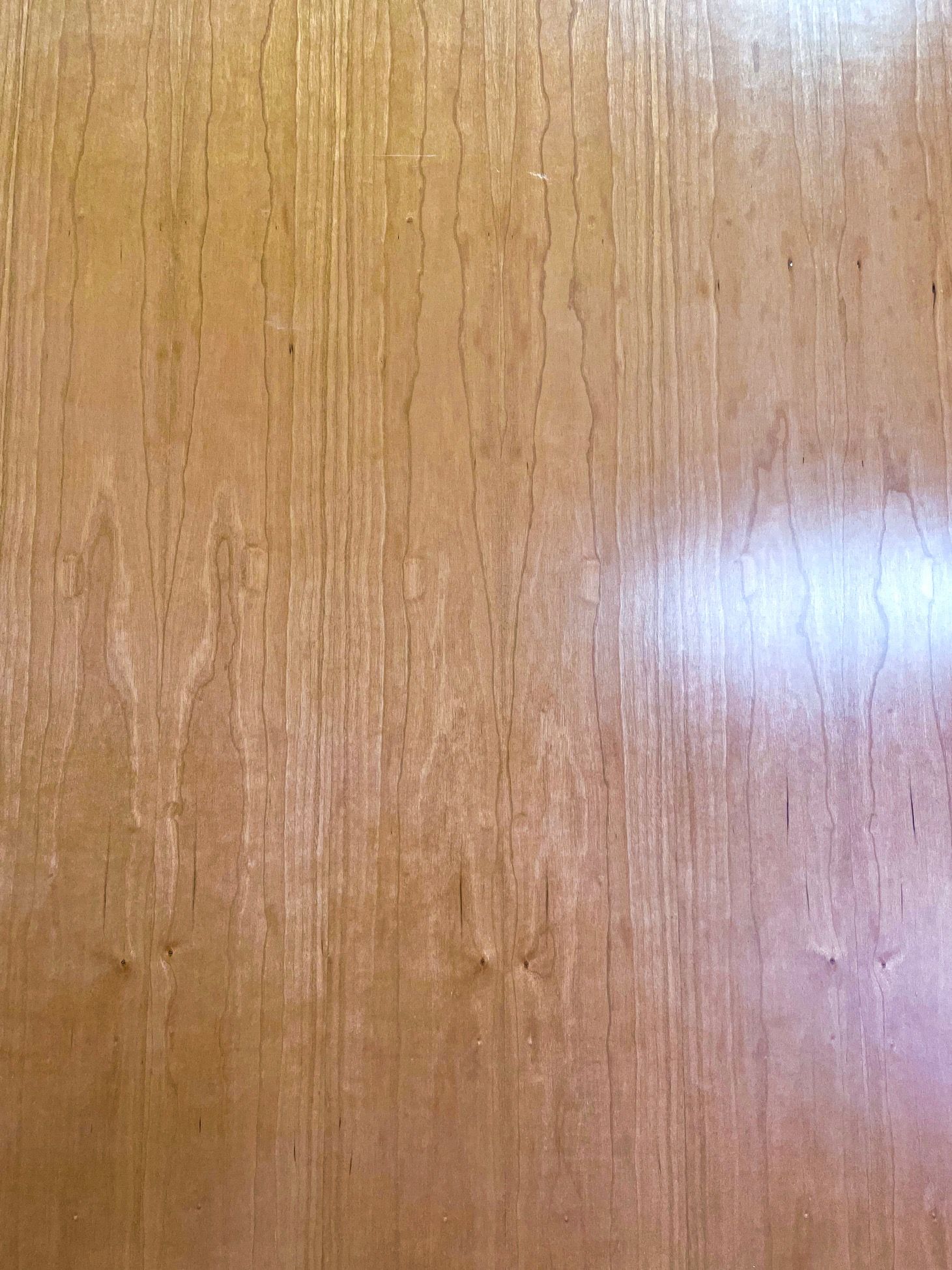 A close up of a piece of wood with a shiny finish.