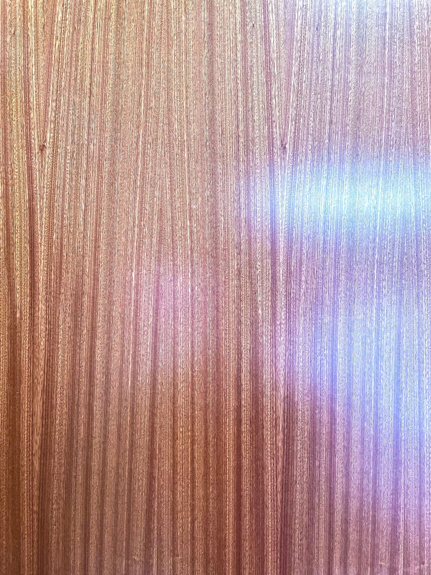 A close up of a piece of wood with a shiny finish.