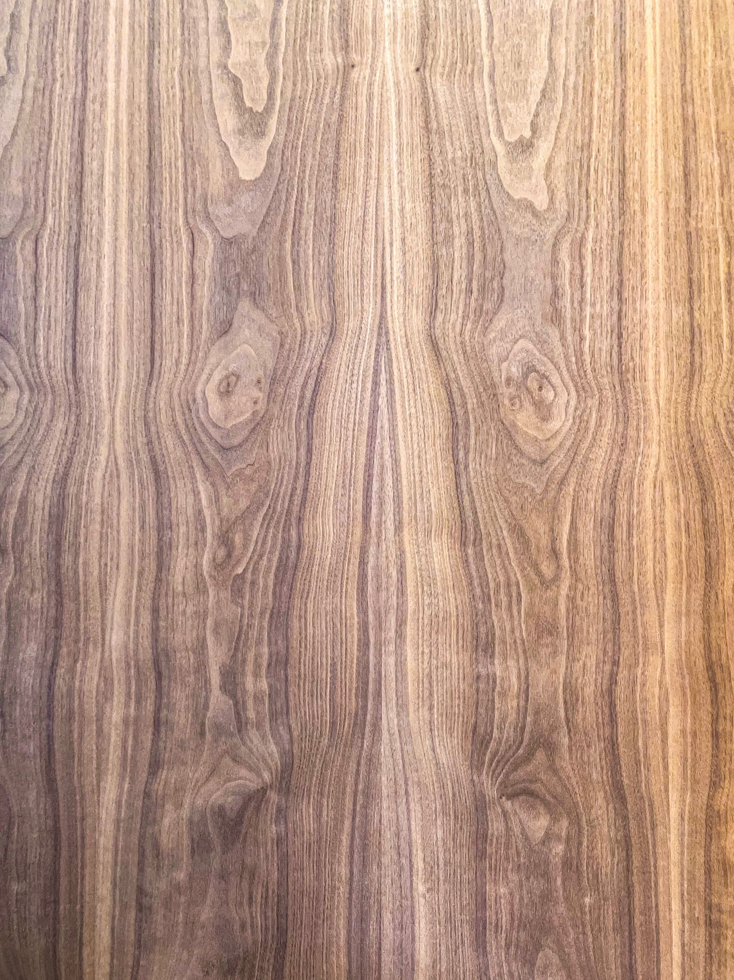 A close up of a piece of wood with a grain pattern.