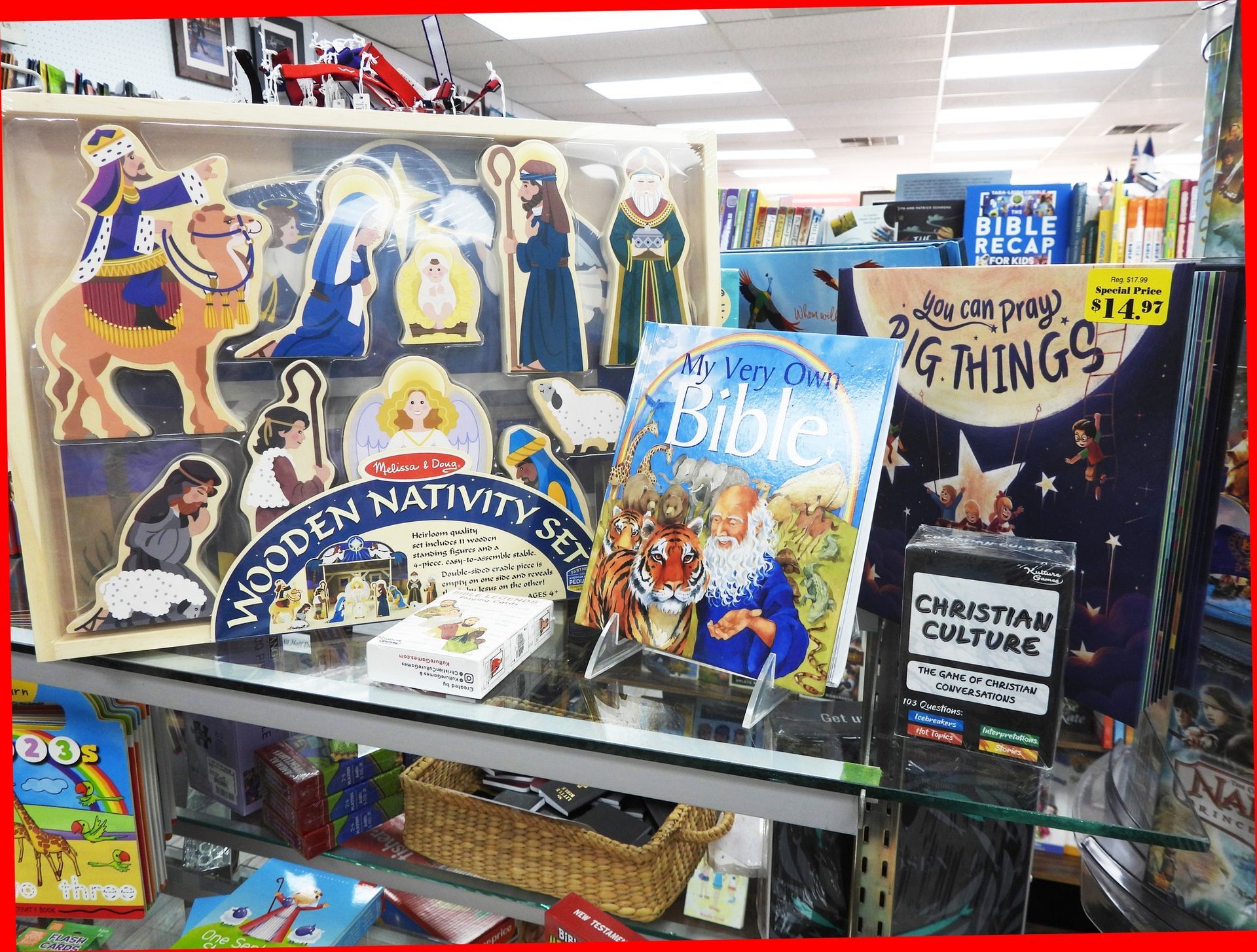 Display of Christian-themed books and wooden nativity set for sale in a store.