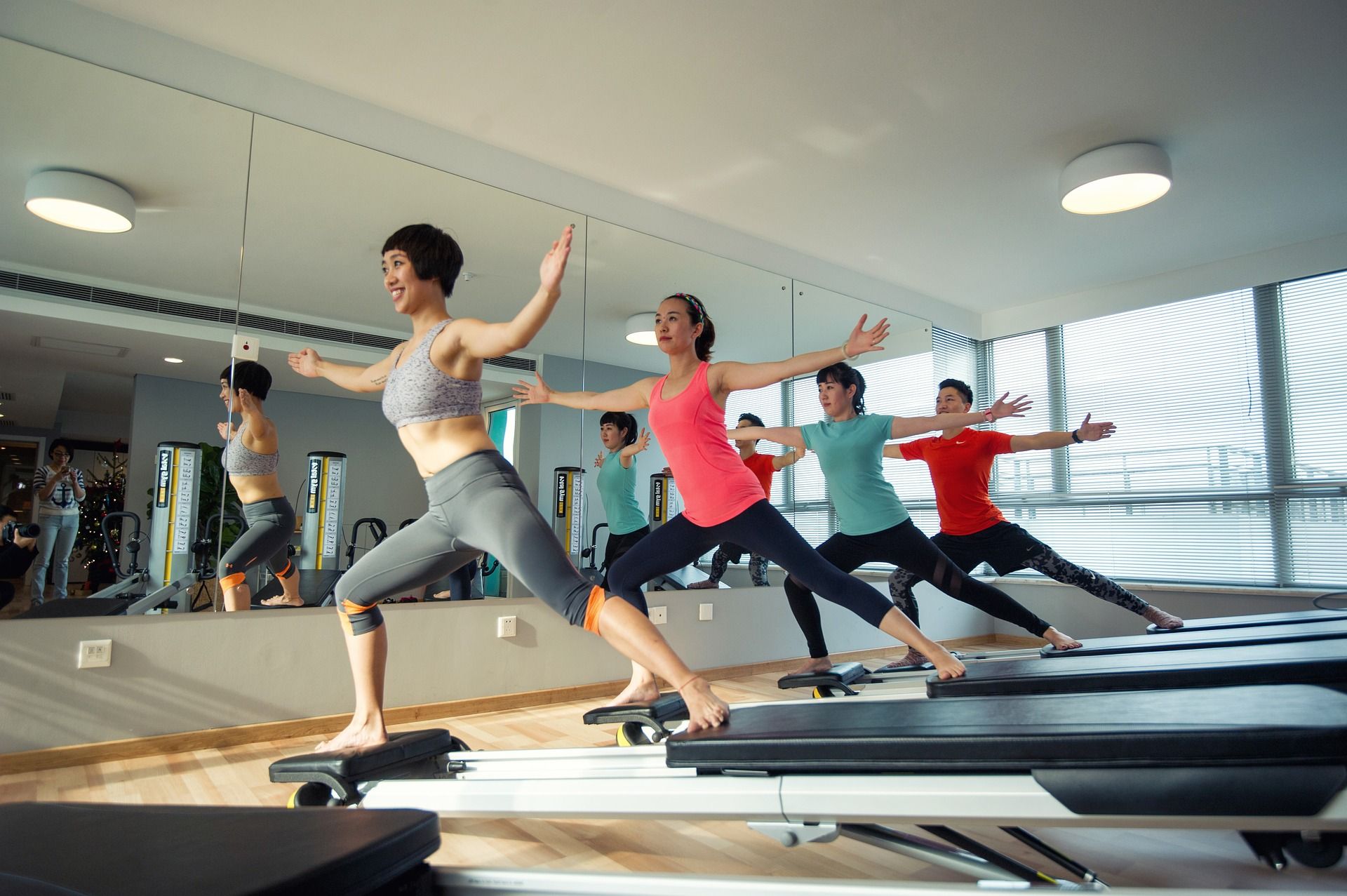 Four people taking a pilates class