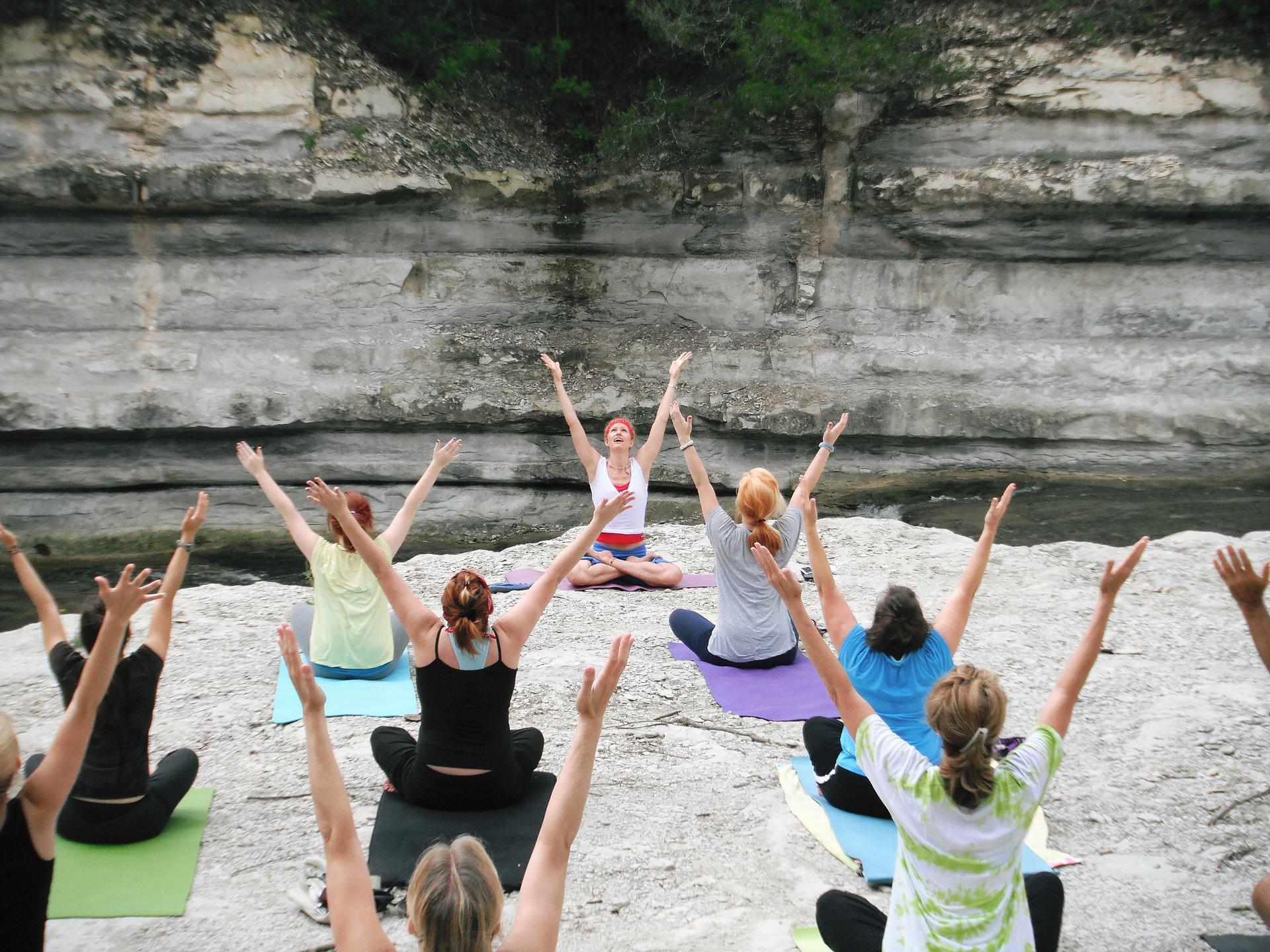 yoga group sitting with outstretched arms