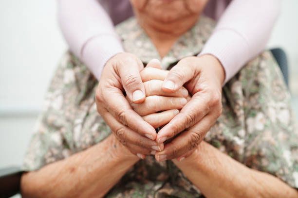 A Woman Is Holding the Hands of An Elderly Woman — Marlton, NJ — Luna Lymphatic Care