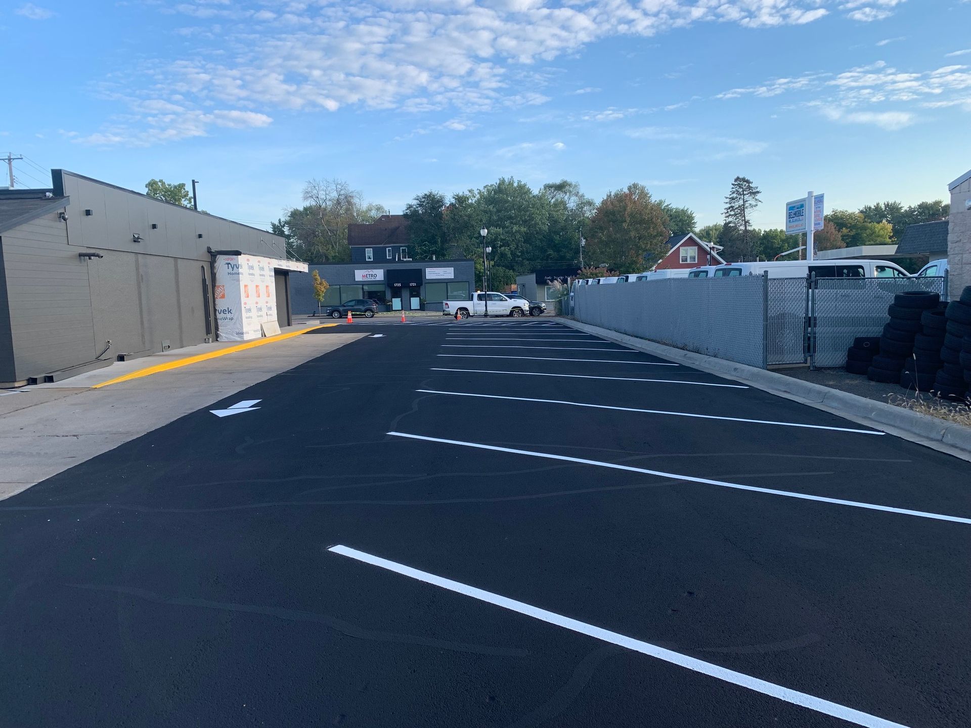 An empty parking lot in front of a shopping center