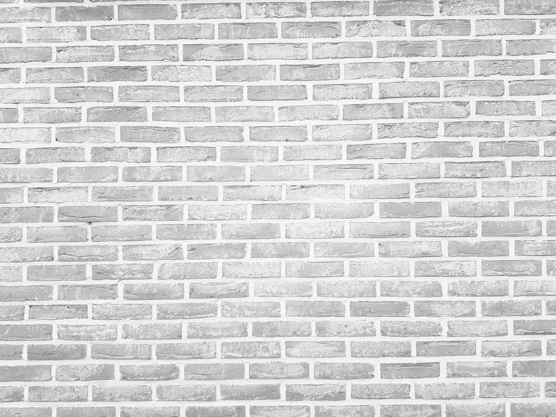 Gray brick wall with horizontal and vertical grout lines.