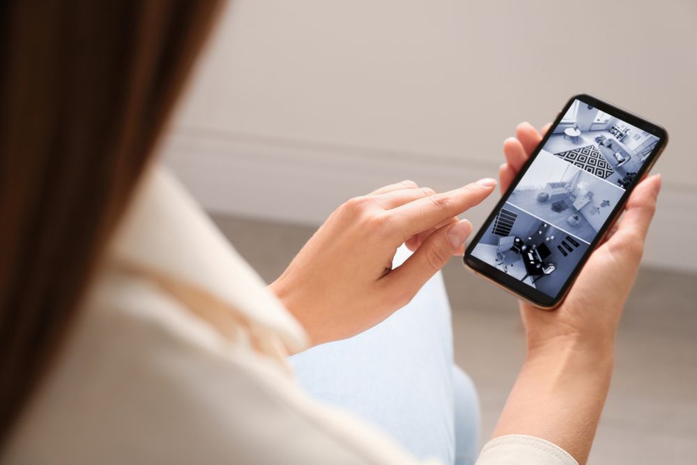 Woman Using a Smartphone to View Security Camera Footage — NQ Video Surveillance in Bungalow, QLD