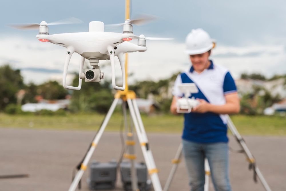White Drone Hovering Controlled by Person in Hard Hat — NQ Video Surveillance in Bungalow, QLD